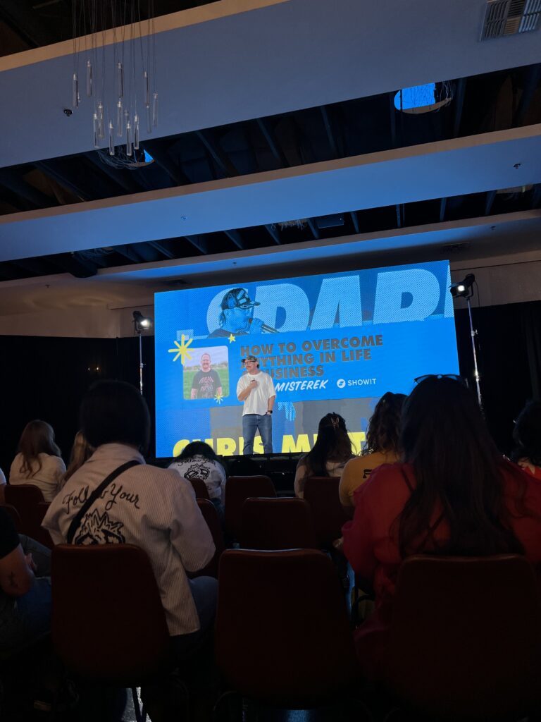 Chris Mistrick's Seasons & Assignments talk during Spark 2025 conference. Chris on stage with a microphone.